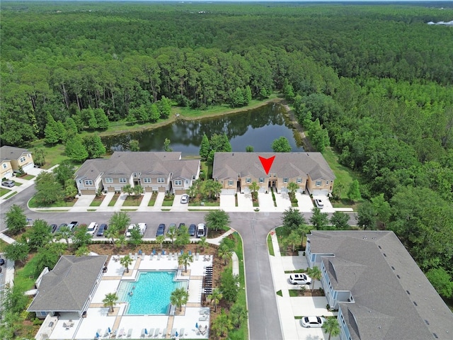 5509 Cumberland Star Ct, Lutz, FL 33558 - aerial overview of property's location with a heavily wooded area, a pool, nearby suburban area, and a large body of water