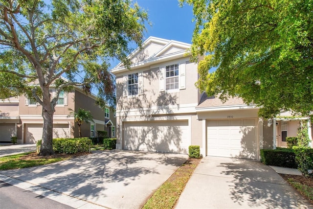 view of front of property featuring an attached garage, driveway, and stucco siding