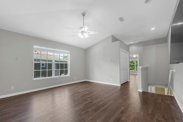 unfurnished living room featuring lofted ceiling, visible vents, baseboards, dark wood finished floors, and a ceiling fan