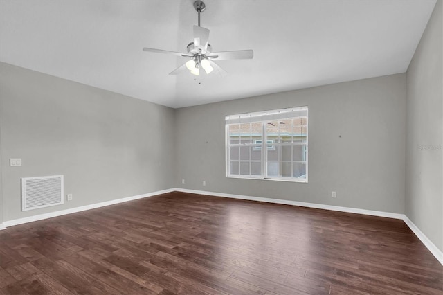 unfurnished room featuring baseboards, visible vents, ceiling fan, and dark wood-type flooring