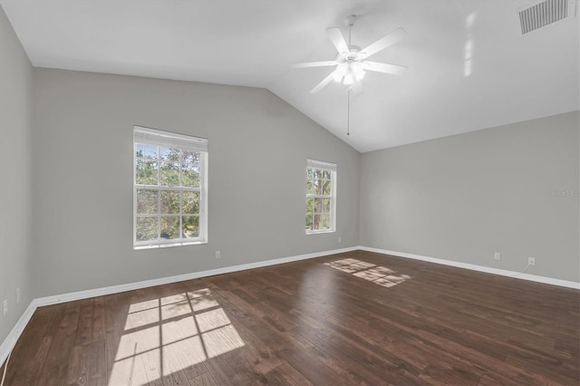spare room featuring ceiling fan, wood finished floors, visible vents, and a healthy amount of sunlight