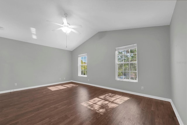 unfurnished room featuring baseboards, wood finished floors, ceiling fan, and vaulted ceiling
