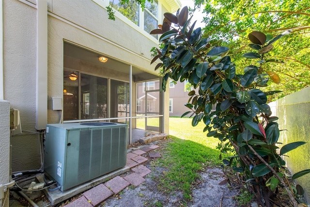 view of yard featuring central AC unit and a sunroom