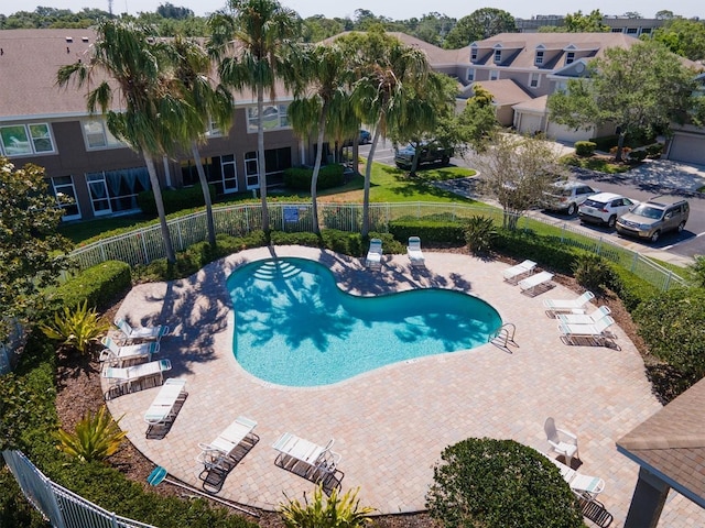pool featuring fence and a patio