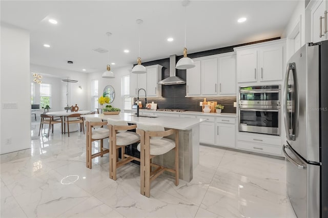 19554 Roseate Dr, Lutz, FL 33558 - kitchen with wall chimney range hood, appliances with stainless steel finishes, marble finish floor, light countertops, and decorative backsplash