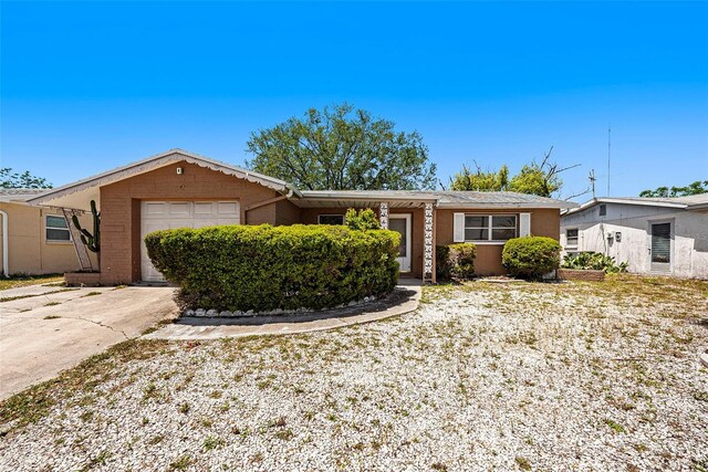 1051 Normandy Blvd, Holiday, FL 34691 - ranch-style house with driveway and a garage