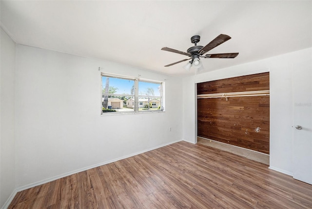 1051 Normandy Blvd, Holiday, FL 34691 - unfurnished bedroom featuring baseboards, wood finished floors, and a closet