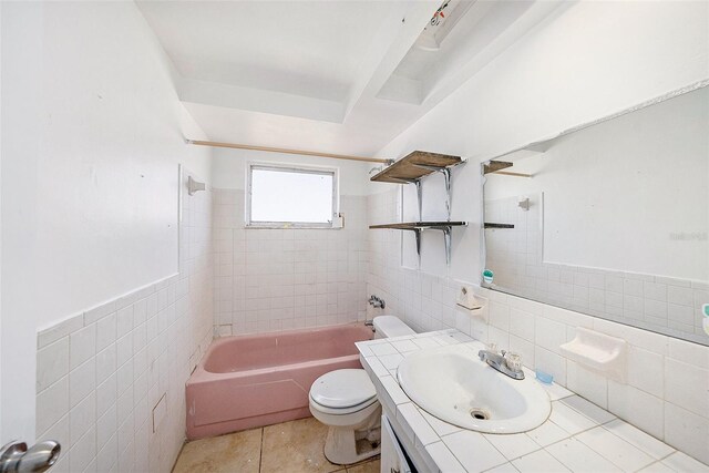 1051 Normandy Blvd, Holiday, FL 34691 - bathroom with tile patterned floors, toilet, tile walls, shower / bathtub combination, and vanity