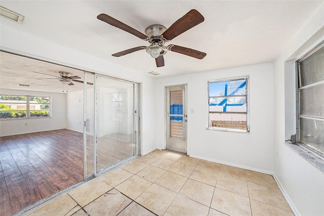 1051 Normandy Blvd, Holiday, FL 34691 - unfurnished room featuring baseboards, a ceiling fan, visible vents, and light tile patterned flooring