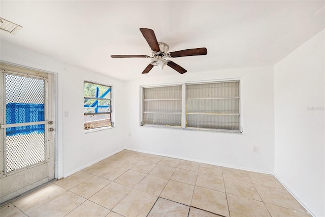 1051 Normandy Blvd, Holiday, FL 34691 - unfurnished room featuring light tile patterned floors, baseboards, built in features, and ceiling fan
