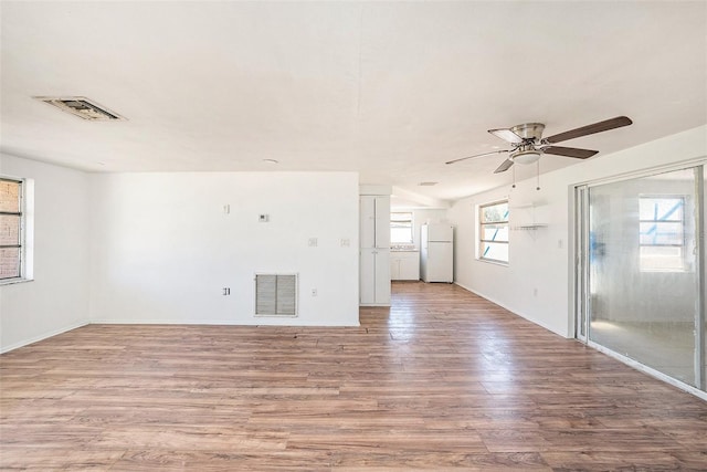 1051 Normandy Blvd, Holiday, FL 34691 - unfurnished living room featuring baseboards, a ceiling fan, visible vents, and light wood-style floors