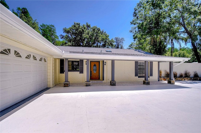 1120 Country Ln, Lutz, FL 33558 - view of front of house with concrete driveway, an attached garage, and a shingled roof