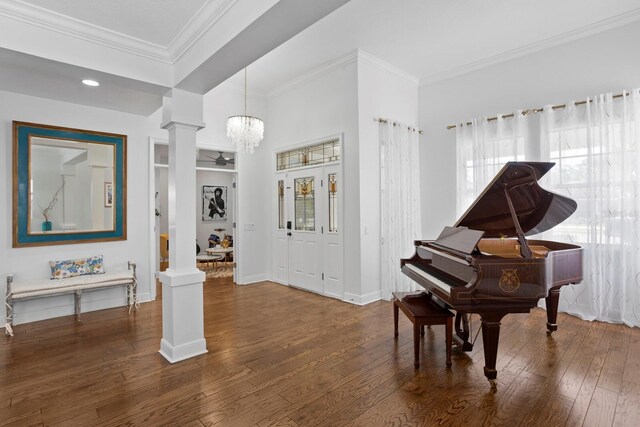 3325 W Wallcraft Ave, Tampa, FL 33611 - interior space with crown molding, baseboards, a notable chandelier, dark wood-type flooring, and decorative columns