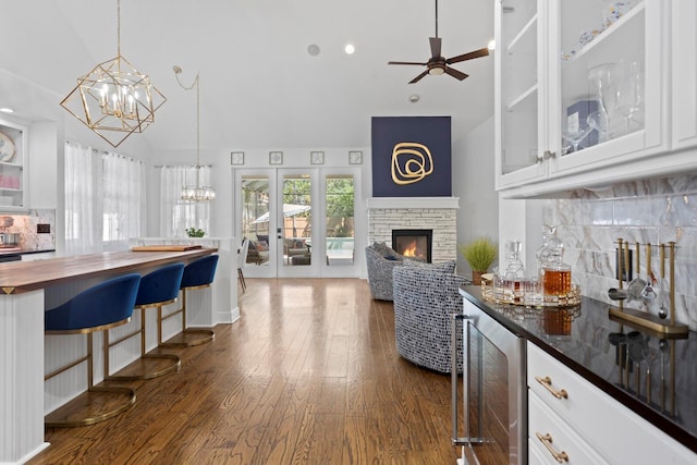 3325 W Wallcraft Ave, Tampa, FL 33611 - kitchen featuring wine cooler, wood counters, high vaulted ceiling, dark wood-style flooring, and ceiling fan with notable chandelier