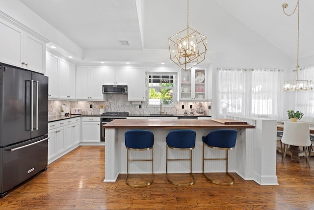 3325 W Wallcraft Ave, Tampa, FL 33611 - kitchen with high end refrigerator, a sink, wood counters, stainless steel oven, and an inviting chandelier