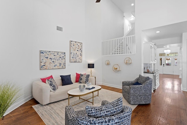 3325 W Wallcraft Ave, Tampa, FL 33611 - living room featuring a high ceiling, baseboards, dark wood-style flooring, and visible vents