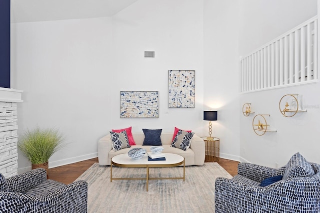 3325 W Wallcraft Ave, Tampa, FL 33611 - living room with wood finished floors, a towering ceiling, a fireplace, baseboards, and visible vents