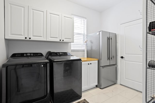 3325 W Wallcraft Ave, Tampa, FL 33611 - washroom with marble finish floor, cabinet space, and washing machine and dryer