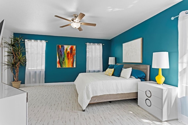 3325 W Wallcraft Ave, Tampa, FL 33611 - bedroom with wood finished floors, a ceiling fan, and baseboards