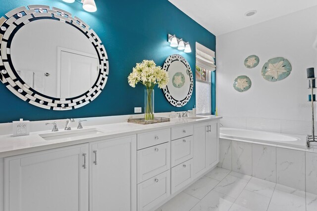 3325 W Wallcraft Ave, Tampa, FL 33611 - bathroom featuring a bath, marble finish floor, a sink, and double vanity