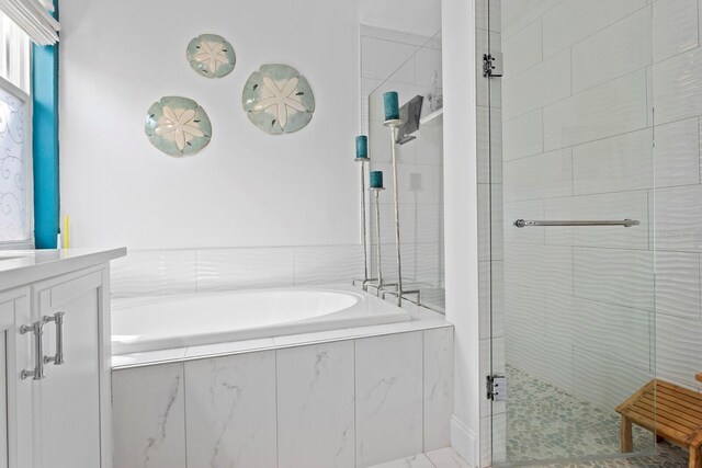 3325 W Wallcraft Ave, Tampa, FL 33611 - full bathroom featuring a garden tub, vanity, and tiled shower