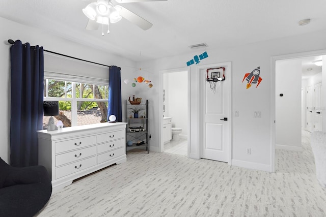 3325 W Wallcraft Ave, Tampa, FL 33611 - bedroom featuring ceiling fan, baseboards, ensuite bathroom, and light wood-style flooring