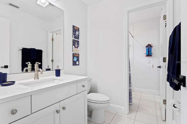 3325 W Wallcraft Ave, Tampa, FL 33611 - bathroom with tile patterned floors, toilet, baseboards, visible vents, and vanity