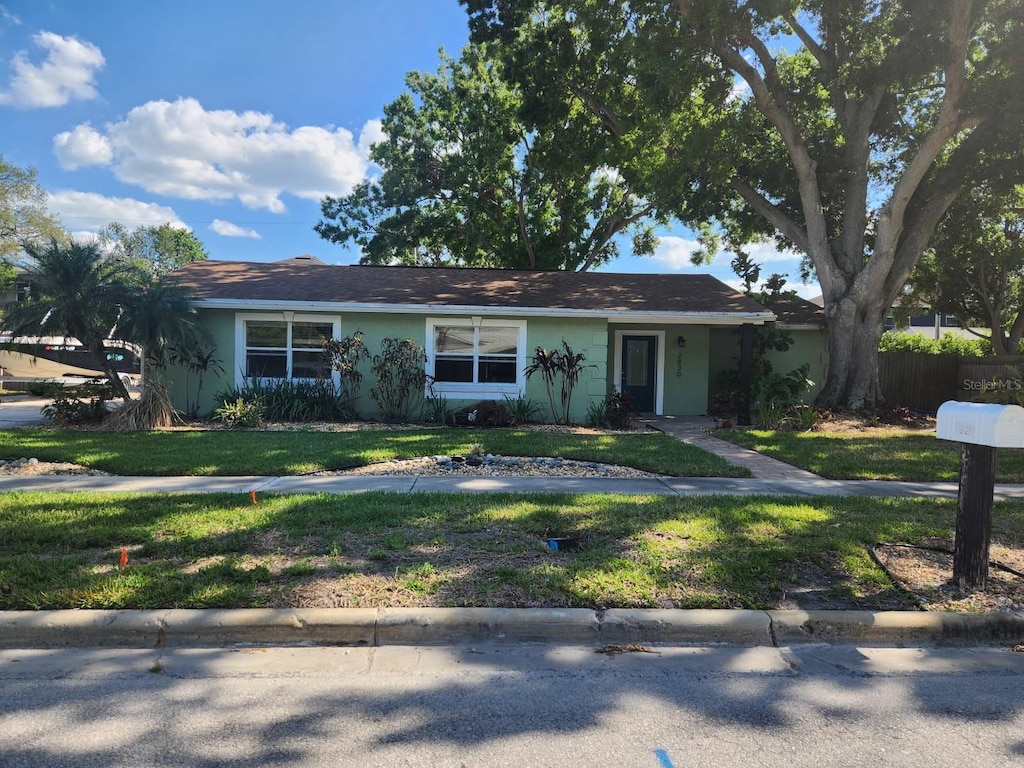 2830 W Bay Haven Dr, Tampa, FL 33611 - ranch-style home featuring stucco siding and a front lawn