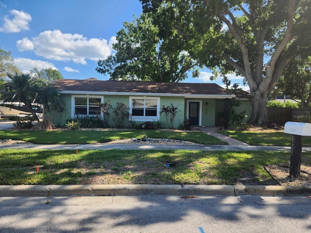 2830 W Bay Haven Dr, Tampa, FL 33611 - ranch-style home featuring stucco siding and a front lawn