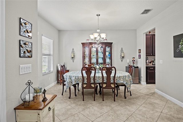 21383 Southern Charm Dr, Land O Lakes, FL 34637 - dining area with visible vents, baseboards, a chandelier, and light tile patterned floors