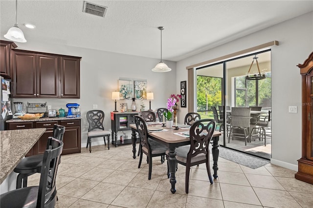 21383 Southern Charm Dr, Land O Lakes, FL 34637 - dining space with visible vents, a textured ceiling, baseboards, and light tile patterned flooring