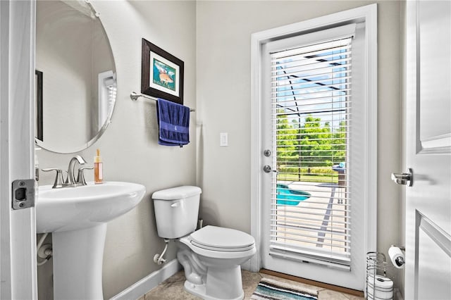 21383 Southern Charm Dr, Land O Lakes, FL 34637 - bathroom with toilet, baseboards, and a sink