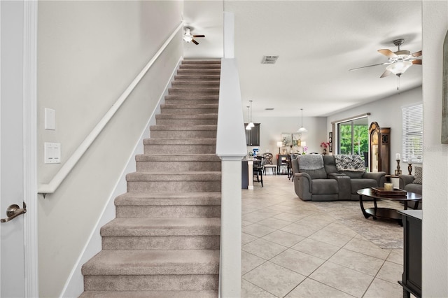 21383 Southern Charm Dr, Land O Lakes, FL 34637 - staircase with visible vents, ceiling fan, and tile patterned floors