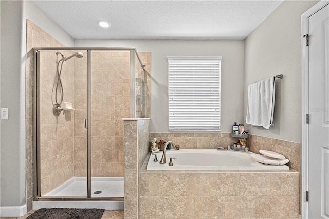 21383 Southern Charm Dr, Land O Lakes, FL 34637 - bathroom with a shower stall, tile patterned floors, a textured ceiling, and a garden tub