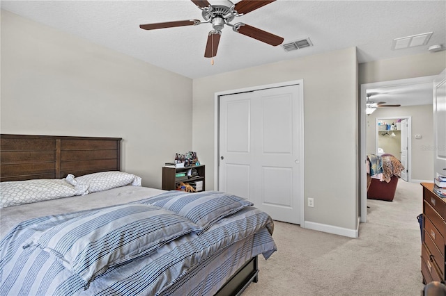 21383 Southern Charm Dr, Land O Lakes, FL 34637 - bedroom with a closet, baseboards, a ceiling fan, visible vents, and light colored carpet