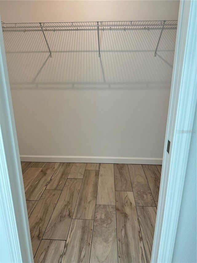 spacious closet featuring wood finished floors