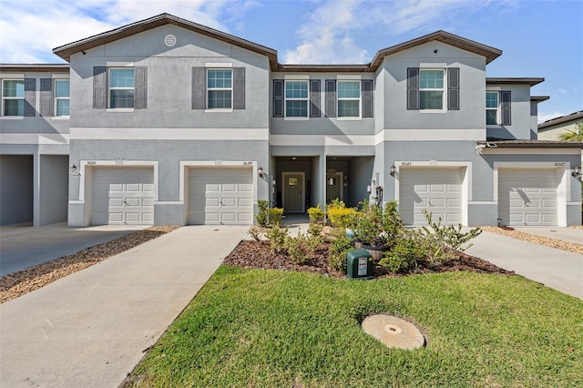 36519 Garden Wall Way, Zephyrhills, FL 33541 - multi unit property with an attached garage, stucco siding, driveway, and a front yard