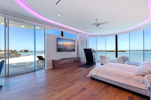 12650 7th St E, Treasure Island, FL 33706 - bedroom with access to outside, expansive windows, and wood finished floors