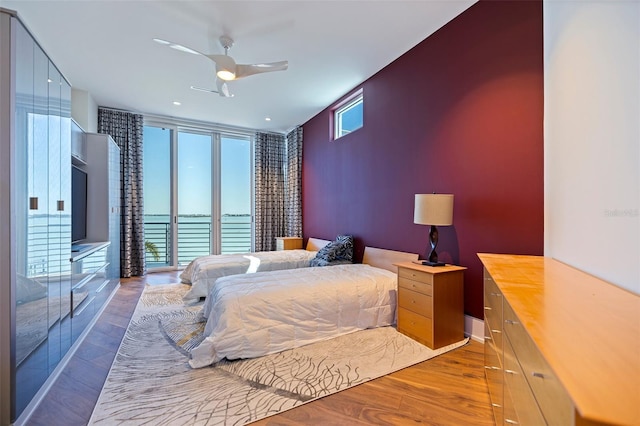 12650 7th St E, Treasure Island, FL 33706 - bedroom with multiple windows, wood finished floors, and baseboards