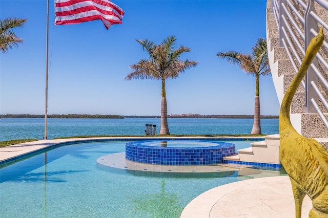 12650 7th St E, Treasure Island, FL 33706 - view of swimming pool with a pool with connected hot tub and a water view