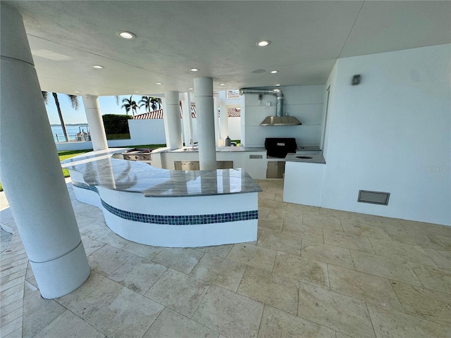 12650 7th St E, Treasure Island, FL 33706 - exterior space with recessed lighting, white cabinetry, light stone countertops, and extractor fan