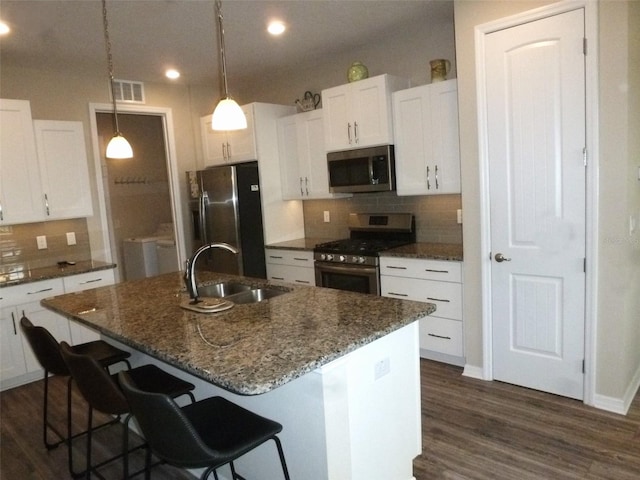 8890 SW 104th Cir, Ocala, FL 34481 - kitchen featuring appliances with stainless steel finishes, a sink, tasteful backsplash, white cabinetry, and recessed lighting