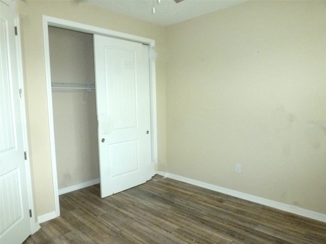 8890 SW 104th Cir, Ocala, FL 34481 - unfurnished bedroom featuring dark wood finished floors, baseboards, and a closet