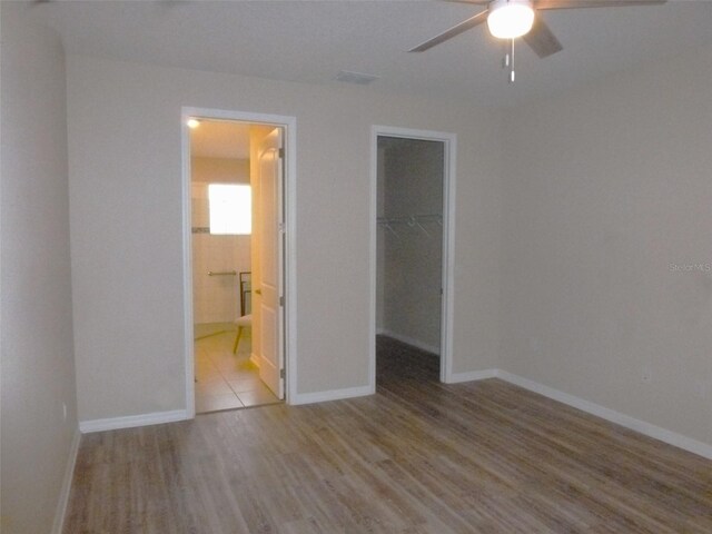 8890 SW 104th Cir, Ocala, FL 34481 - unfurnished bedroom featuring wood finished floors, a spacious closet, a closet, and baseboards