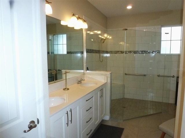 8890 SW 104th Cir, Ocala, FL 34481 - bathroom with double vanity, tiled shower, tile patterned floors, and recessed lighting