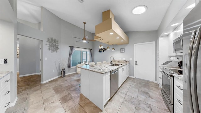 1613 E Del Webb Blvd, Sun City Center, FL 33573 - kitchen featuring appliances with stainless steel finishes, a peninsula, a sink, white cabinetry, and ceiling fan