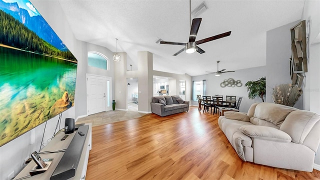 1613 E Del Webb Blvd, Sun City Center, FL 33573 - living room with ceiling fan, wood finished floors, and vaulted ceiling