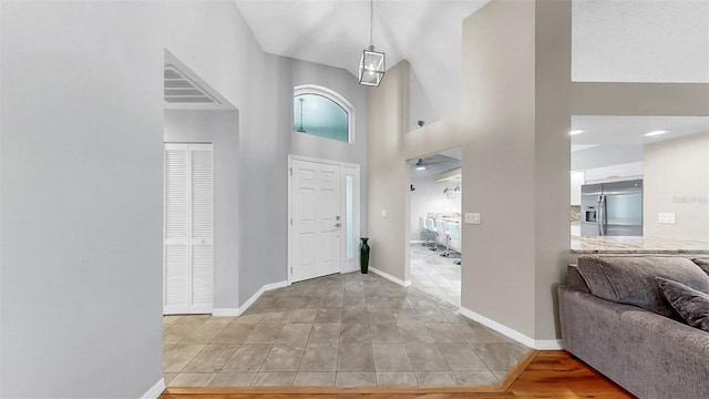 1613 E Del Webb Blvd, Sun City Center, FL 33573 - foyer entrance featuring baseboards, light tile patterned flooring, and a high ceiling