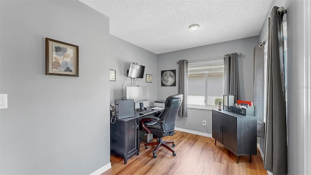 1613 E Del Webb Blvd, Sun City Center, FL 33573 - office with wood finished floors, baseboards, and a textured ceiling