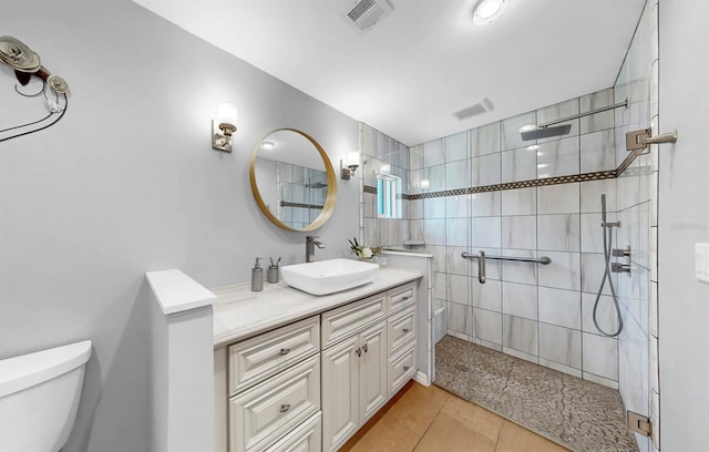 1613 E Del Webb Blvd, Sun City Center, FL 33573 - bathroom with toilet, tile patterned flooring, tiled shower, and vanity